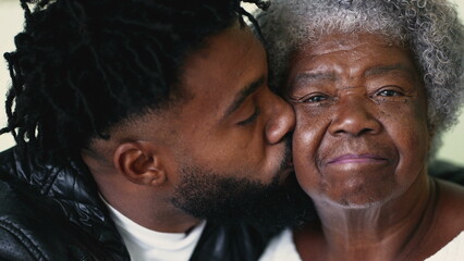 Adult grandson embracing senior grandmother authentic and real life