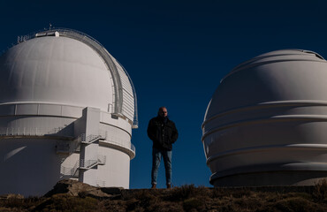 Adult man in front of observatory against blue sky. Almeria, Spain