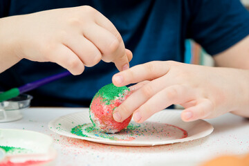 Easter. a Christian religious holiday. Egg mottle with different color salt. Tradition to variegate with various colors and various techniques. Global spring fest.