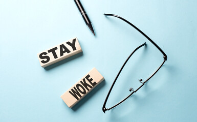 STAY WOKE text on wooden block ,blue background