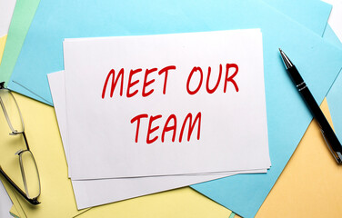 MEET OUR TEAM text on paper on the colorful paper background