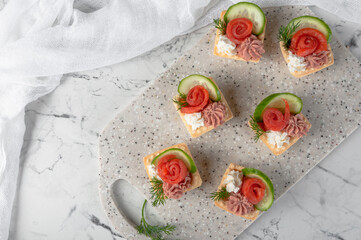 Tartlets with stuffing lying on a stone board.