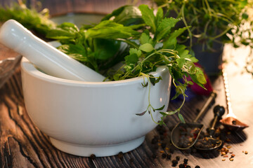 Fresh herbs in mortar and pestle