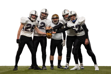 Group of young sportive men, professional american football players in sports uniform and equipment posing isolated on white background.