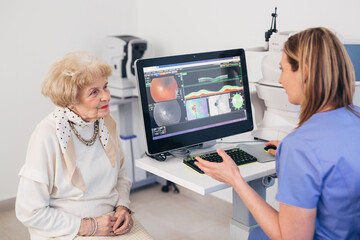 older woman has eye examination. digital retina scanner - obrazy, fototapety, plakaty