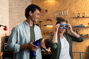 Two people in a carpentry workshop being filmed with a camera for a blog