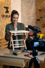 DIY carpenter filming a blog about wooden chair