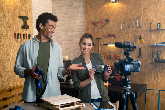 Two people in a carpentry workshop being filmed with a camera for a blog