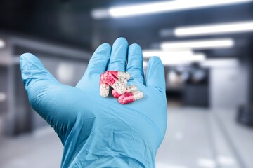 Researcher with oral pill pharmaceutical antiviral drugs against covid-19 coronavirus.