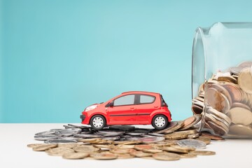 Car tax concept. Stack of coins with toy car. saving money for transport