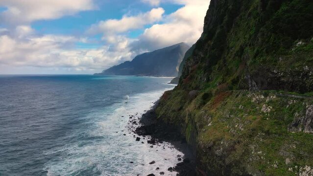 The Atlantic ocean seaside with a waterfall. The seashore waterfall on Madeira.