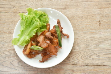 fried slice salty pork with lettuce on plate
