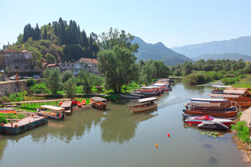 Fototapeta na wymiar Virpazar Montenegro , boats in water canal 