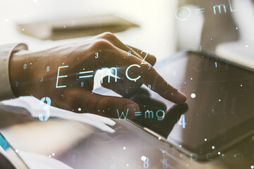 Double exposure of creative scientific formula concept with finger clicks on a digital tablet on...