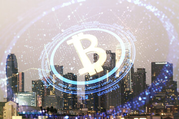 Virtual Bitcoin hologram on Los Angeles skyline background. Multiexposure