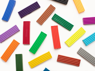 Colorful plasticine modelling clay sticks pattern isolated on white background with clipping path. Top view.