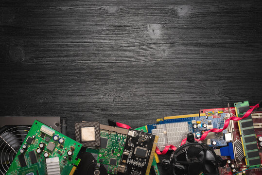 Old computer parts on the wooden flat lay table background with copy space. Computer repair service.