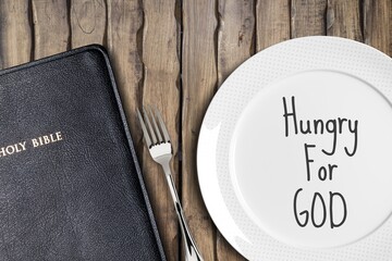 Fasting and prayer. Christian biblical concept, empty plate with Holy Bible.