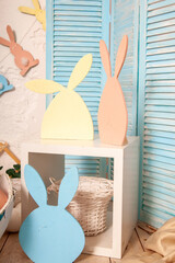 Easter photo zone with flags in shape of rabbits and wood easter rabbit decoration indoors