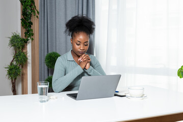 Young concentrated African American woman blogger and human rights activist writing a blog about cyber bullying and racism among young people through her personal negative experience.