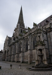 Fototapeta na wymiar Autun, France - February 22 , 2022: The Cathedral of Saint Lazarus of Autun is a Roman Catholic cathedral in the Bourgogne-Franche-Comte. Cloudy winter day. Selective focus.