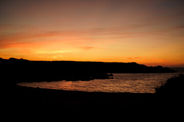 Cala Viola de Ponent, Menorca. September 2021. Magnificent sunset in the Mediterranean Sea. On one of the paradisaical beaches of the island of Menorca.