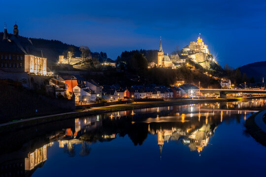 Saarburg panorama in Rhineland-Palatinate near Trier Germany and Luxemburg is a small touristic town with medieval centre. Blue hour twilight atmosphere with lights mirrored in River Saar.