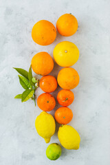 Oranges, tangerines and lemons in overhead view on vintage background
