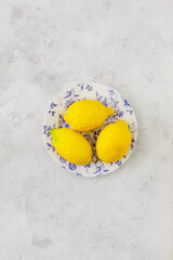 Vintage plate with lemons on vintage white background