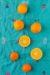 Overhead view of oranges with vintage turquoise background