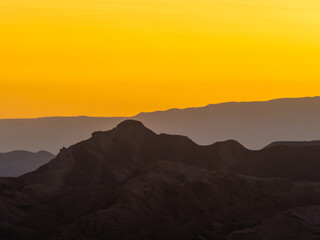 Stunning sunset in the Valle de la Luna (Valley of the Moon), San Pedro de Atacama, Chile. Amazing rock formations, deep canyons and cliffs, huge sand dunes with infinite color and texture variations.
