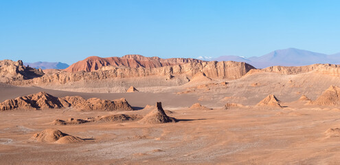 Stunning desert landscapes in the Valley of Moon (Valle de la Luna), San Pedro de Atacama, Chile. Unique rock formations, cliffs sand dunes with infinite color and texture variations.