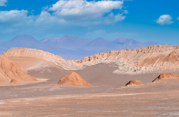 Fototapeta na wymiar Stunning desert landscapes in the Valley of Moon (Valle de la Luna), San Pedro de Atacama, Chile. Unique rock formations, cliffs sand dunes with infinite color and texture variations.