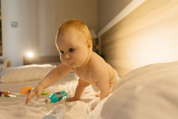 baby in bed, baby child playing with toy, child sitting, portrait of a baby