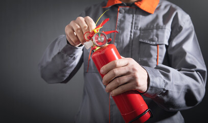 Caucasian fireman holding fire extinguisher.