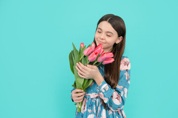 floral present. happy child smell tulips. mothers or womens day.