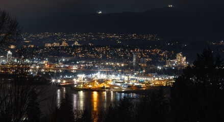 Modern Cityscape at Night with buildings and mountain in background. Taken from Capitol Hill in Burnaby, Vancouver, British Columbia, Canada.