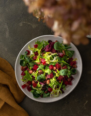 Warm salad with mixed salad with boiled beetroot and beans with spices, top view