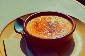 Creme brulee in a cafe in the sun with a baked crust
