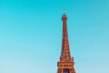 . The Eiffel Tower against a perfectly blue sky. Beauty travel in Paris, touristic place.