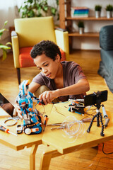 A little engineer building a robot at home.