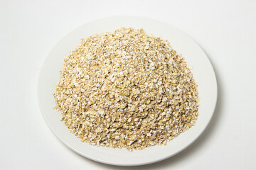 Dry oatmeal on a white background. Healthy and tasty food. Food for weight loss