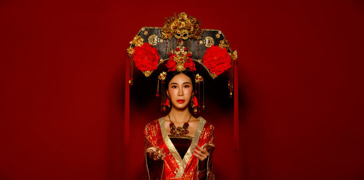 Asian Woman wear China Royal empress traditional costume with golden line design dress and headwear