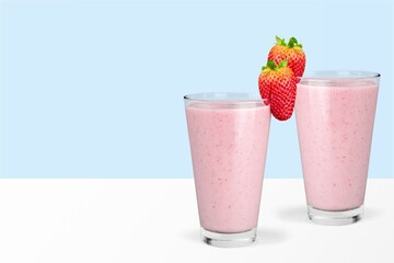 Protein rich smoothies with yogurt and frozen strawberries in glass. Bright berry