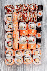 Cold cooked rice dressed with vinegar that is shaped into pieces and topped with raw or cooked fish, or formed into a roll with fish, egg, or vegetables and often wrapped in seaweed.