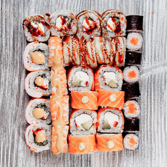 Cold cooked rice dressed with vinegar that is shaped into pieces and topped with raw or cooked fish, or formed into a roll with fish, egg, or vegetables and often wrapped in seaweed.