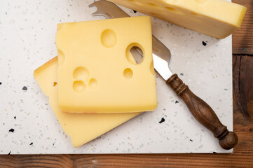 Swiss cheese collection, yellow emmentaler cheese with round holes