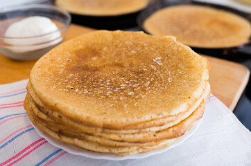 cooking traditional pancakes from wheat flour in the kitchen