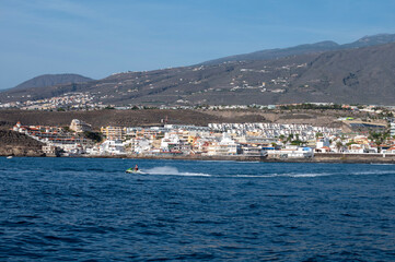 View on resorts and beaches of South coast of Tenerife island during sail boat trip along coastline, Canary islands, Spain