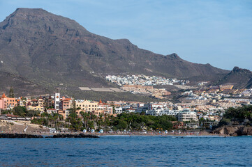 View on resorts and beaches of South coast of Tenerife island during sail boat trip along coastline, Canary islands, Spain